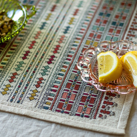 folk embroidery with traditional fabric and bowl of lemon slices