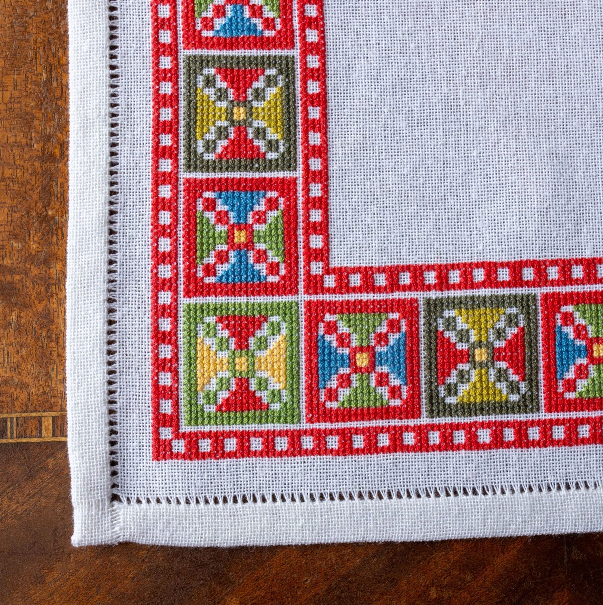 folk embroidery design with red geometric blocks