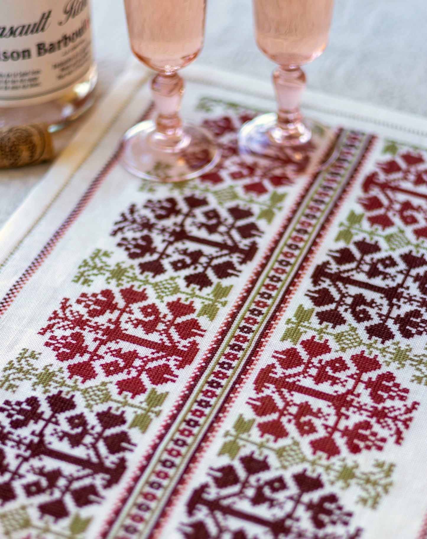 folk embroidery table runner with fig design in red