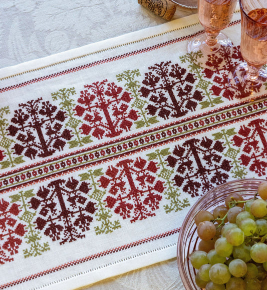 folk embroidery table runner with fig design in red