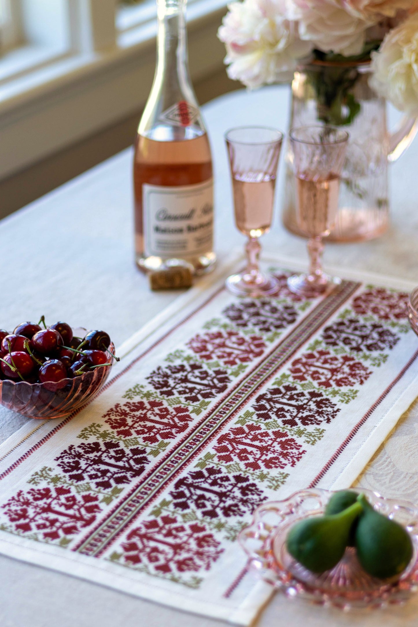 folk embroidery table runner with fig design in red