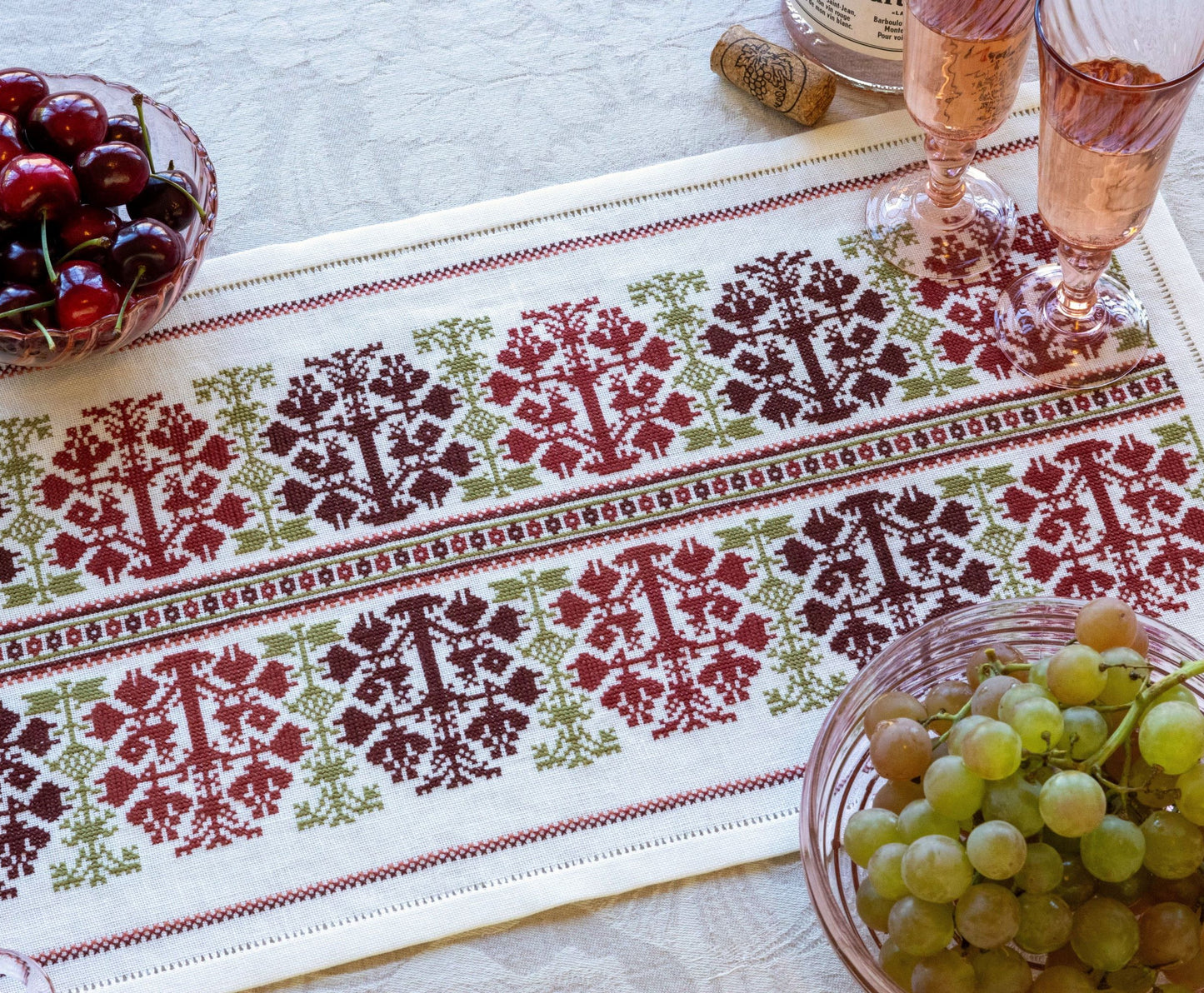 folk embroidery table runner with fig design in red