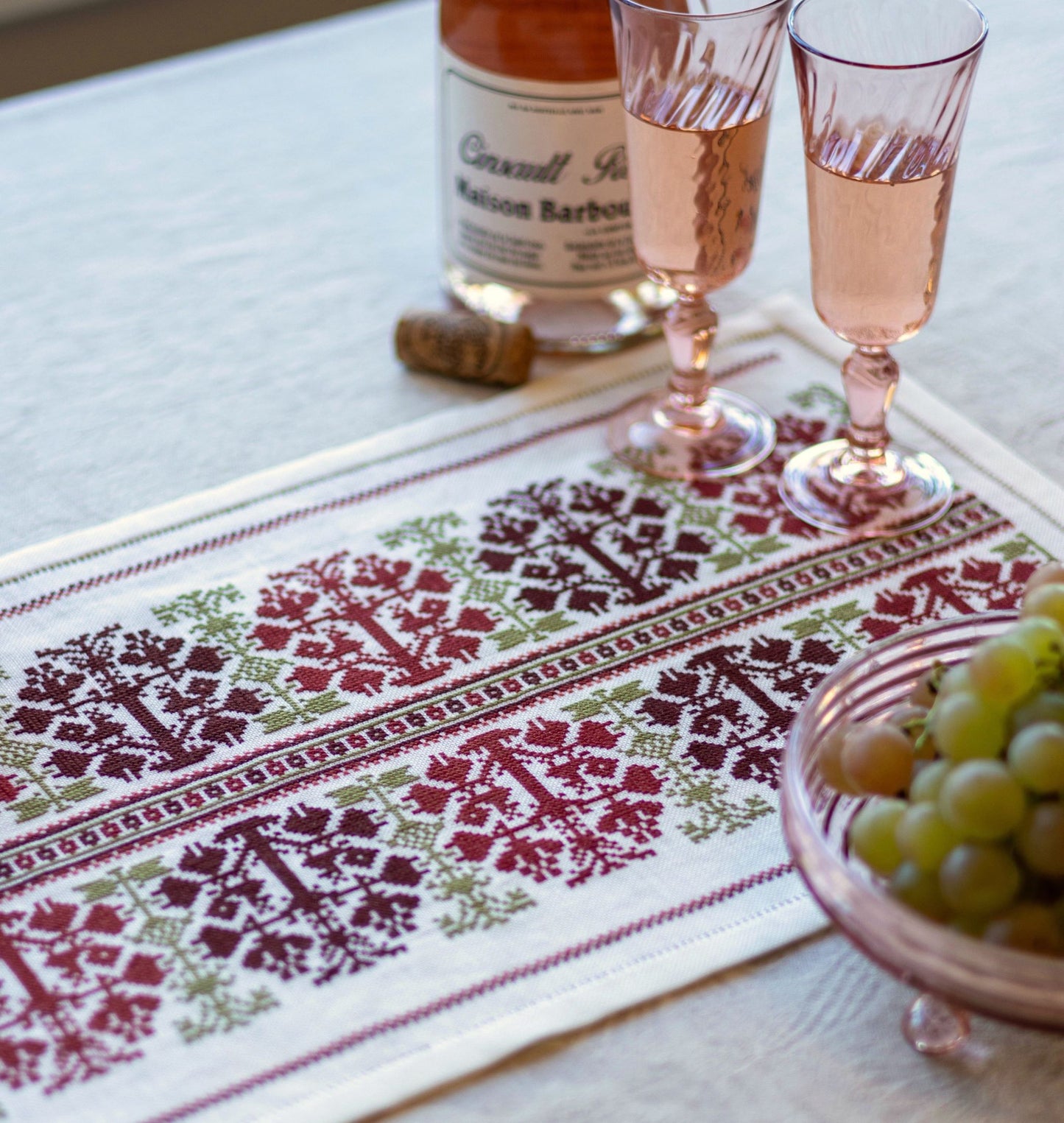 folk embroidery table runner with fig design in red