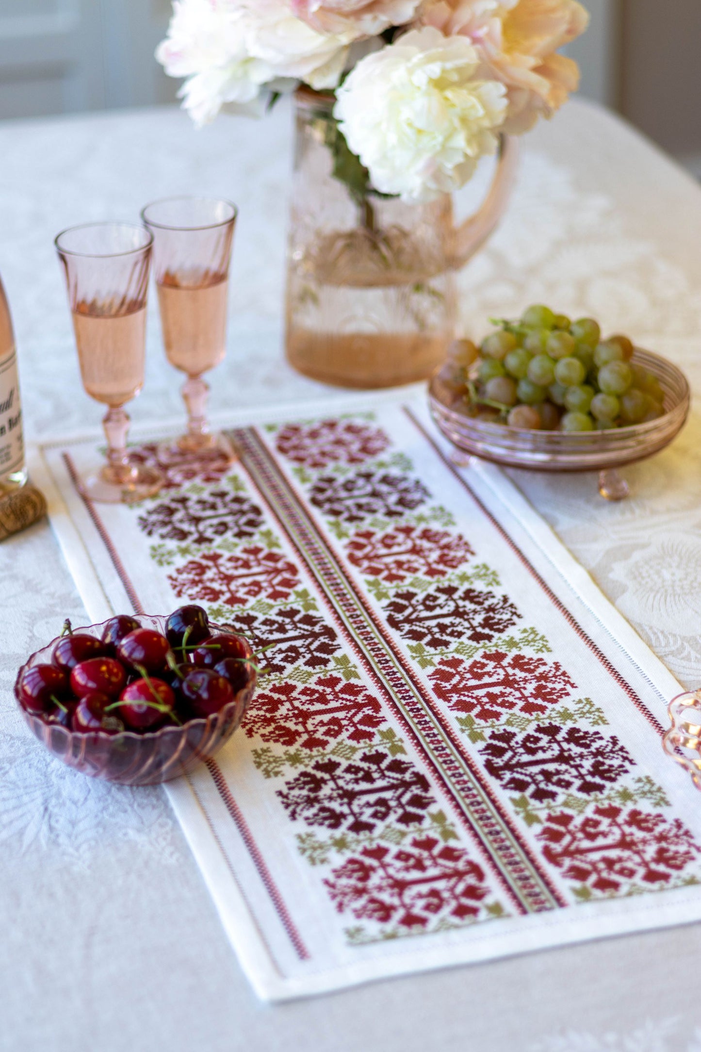 folk embroidery table runner with fig design in red