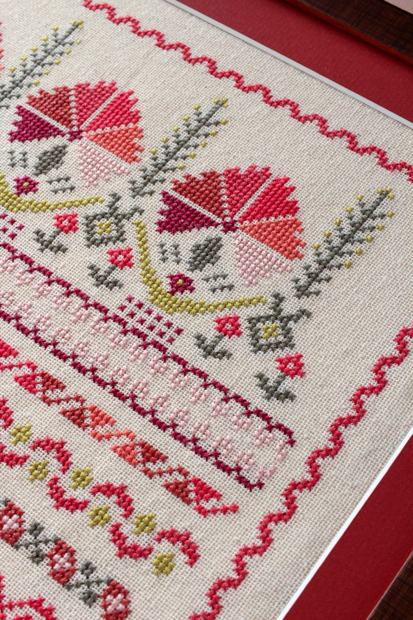 framed folk embroidery with borders in red