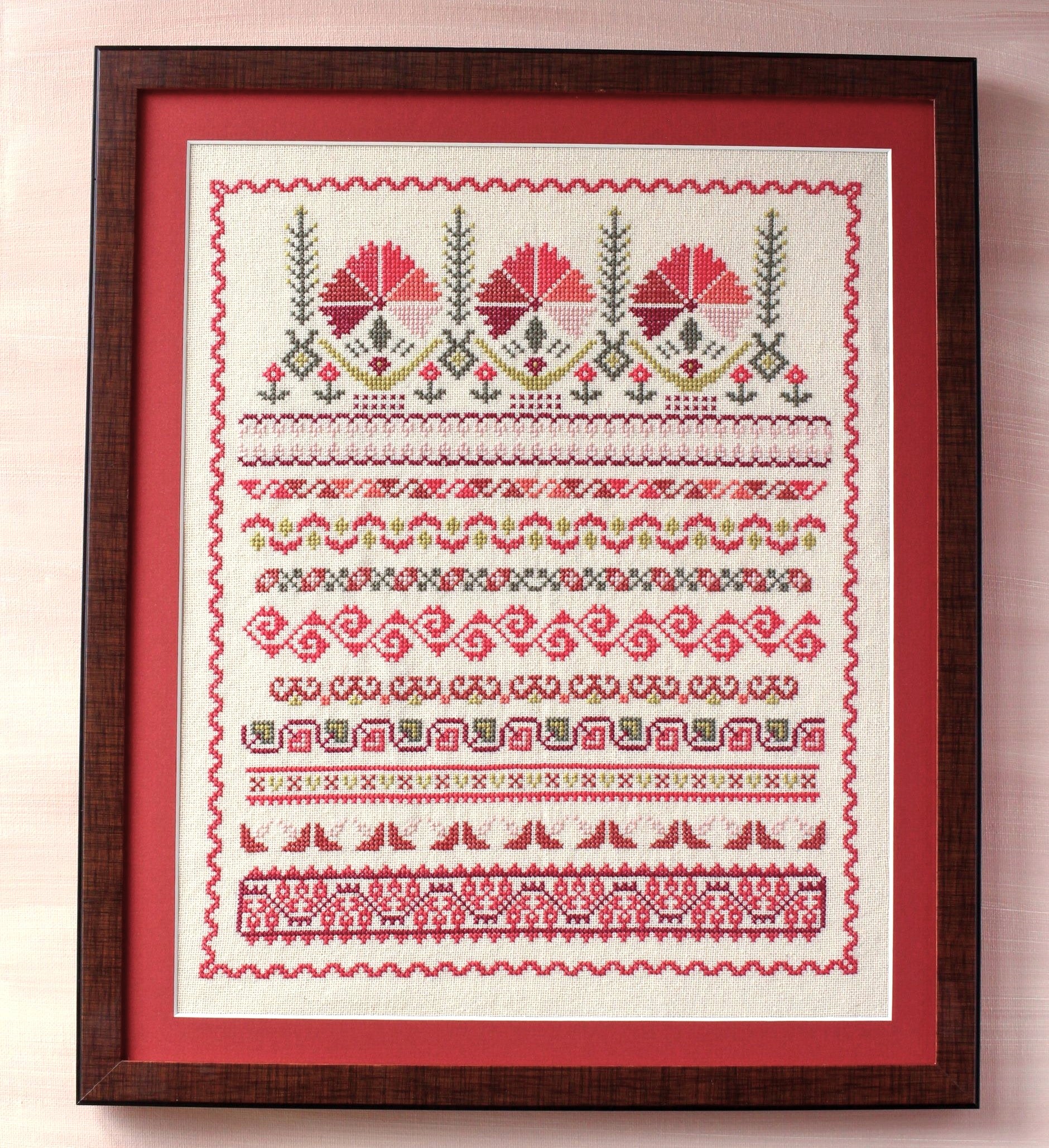 framed folk embroidery with borders in red