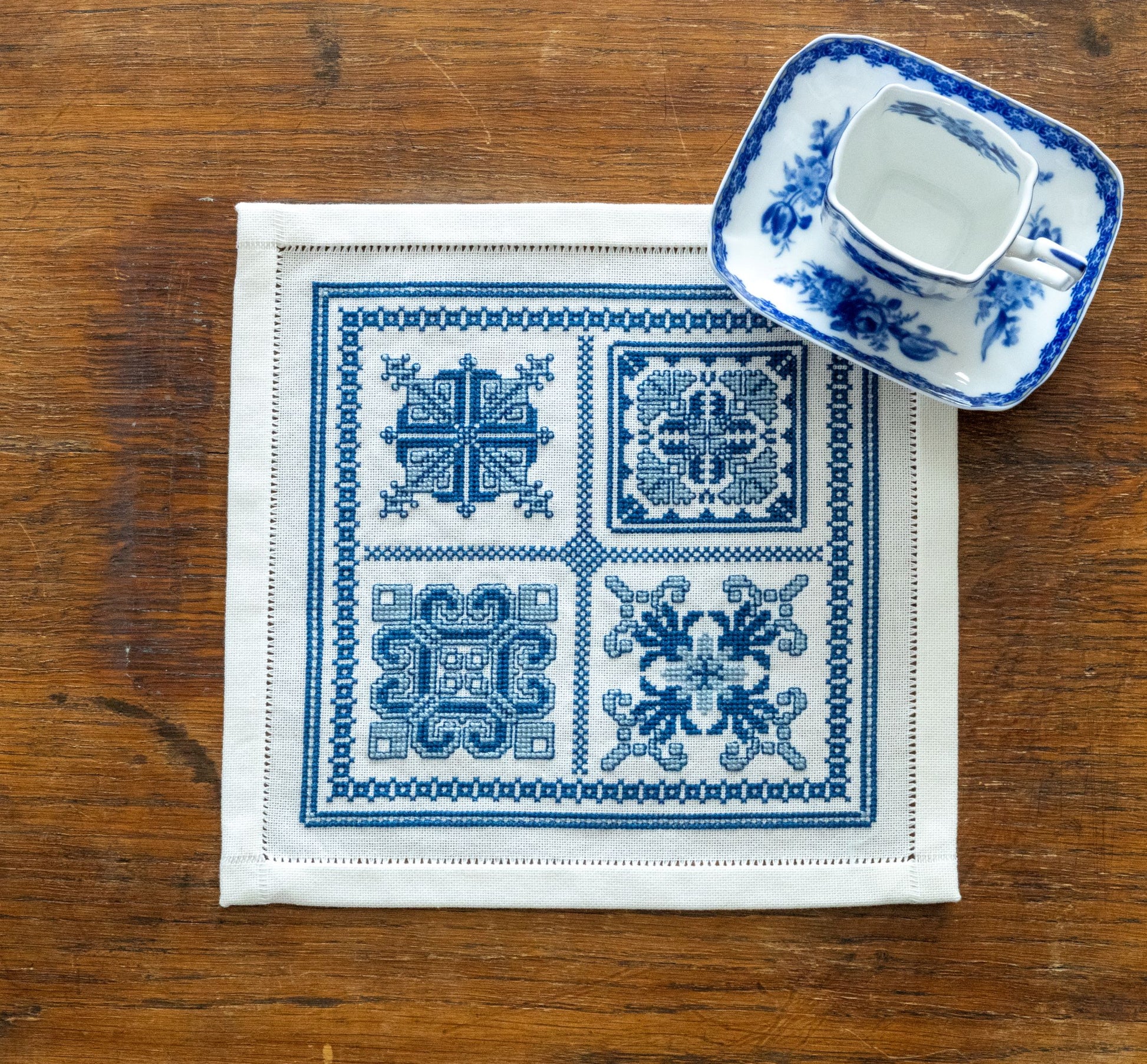 folk embroidery with four blue and white motifs