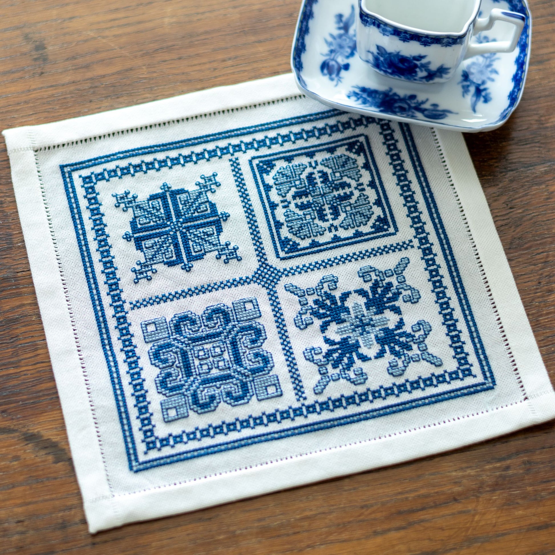 folk embroidery with four blue and white motifs