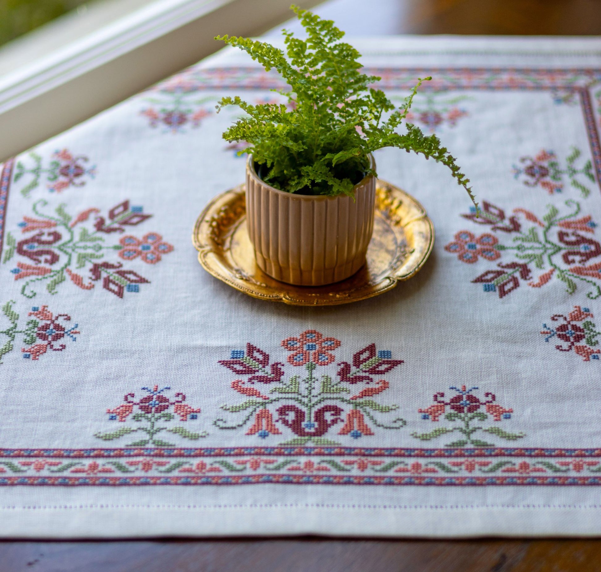 folk embroidery with pink floral design