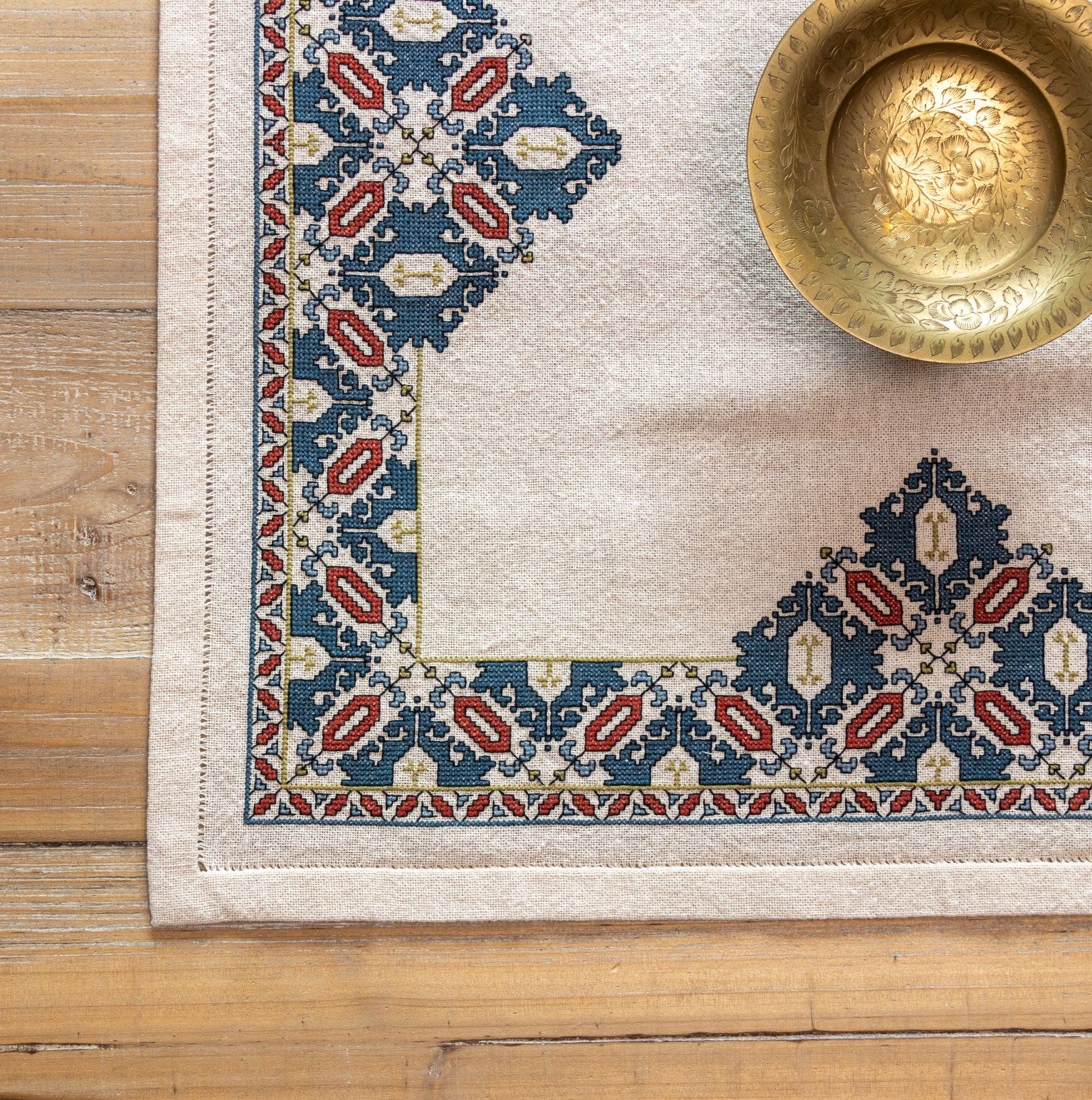 cross stitch folk embroidery textile with mulberry leaf pattern closeup