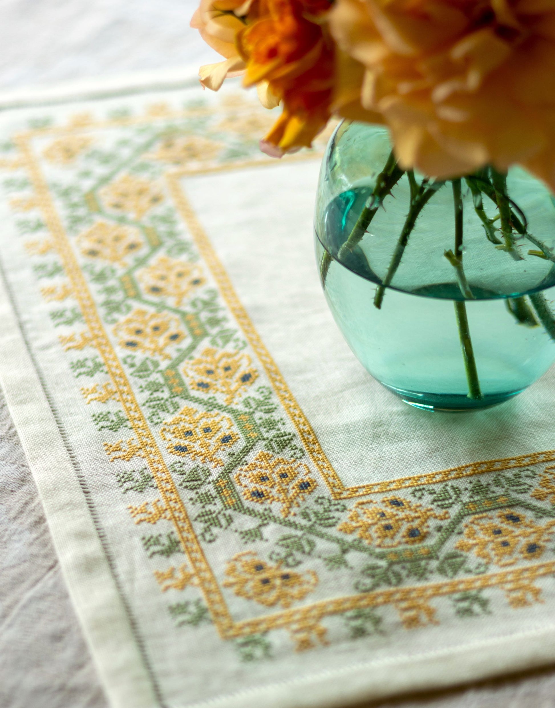 folk embroidery table linen with yellow and green floral design