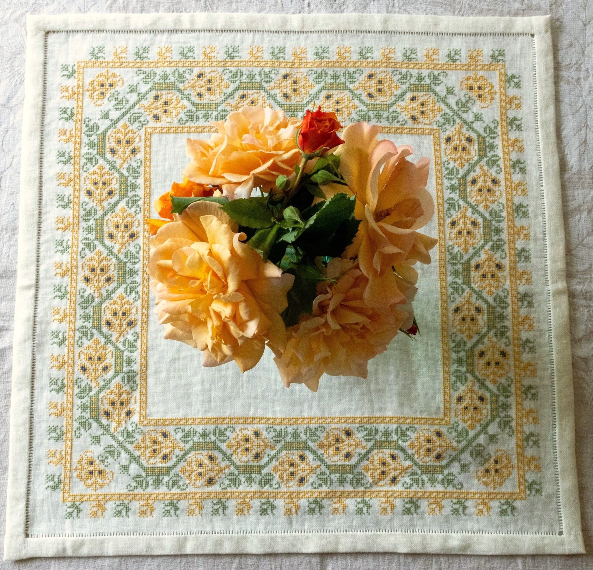 folk embroidery table linen with yellow and green floral design