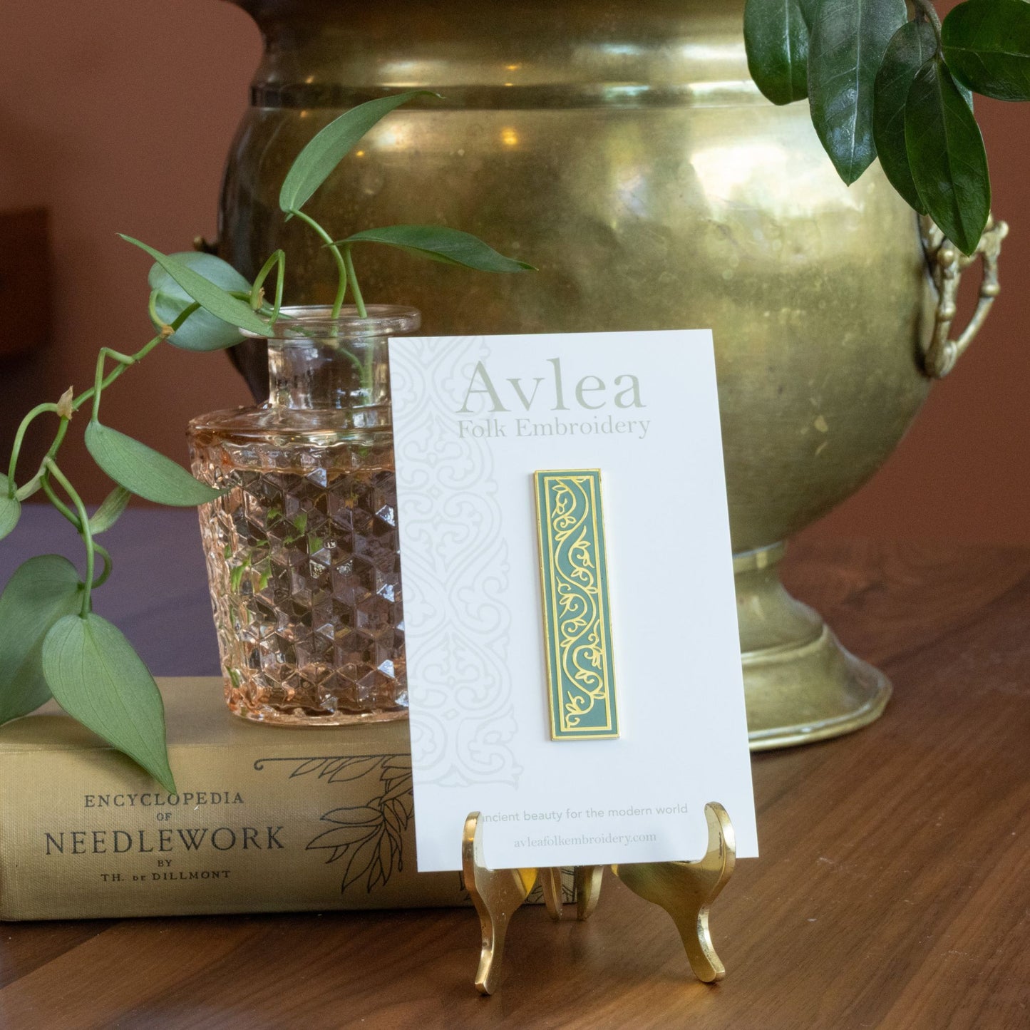 Avlea Folk Embroidery NeedleBar Chloe on stand with book and plants