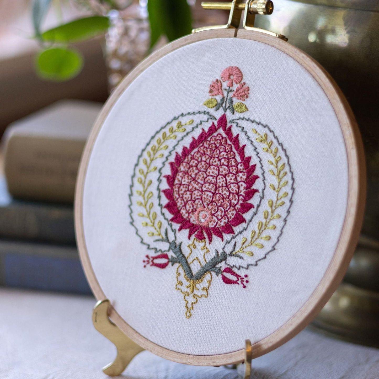 Embroidery hoop with floral design on a stand