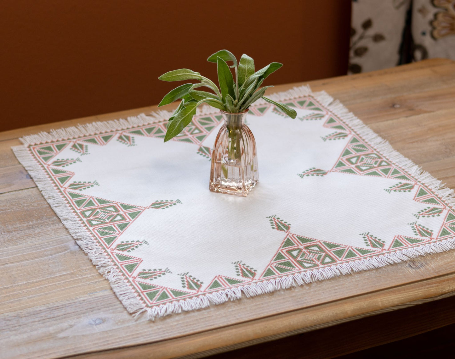 Greek cross stitch folk embroidery tree design on table with plant