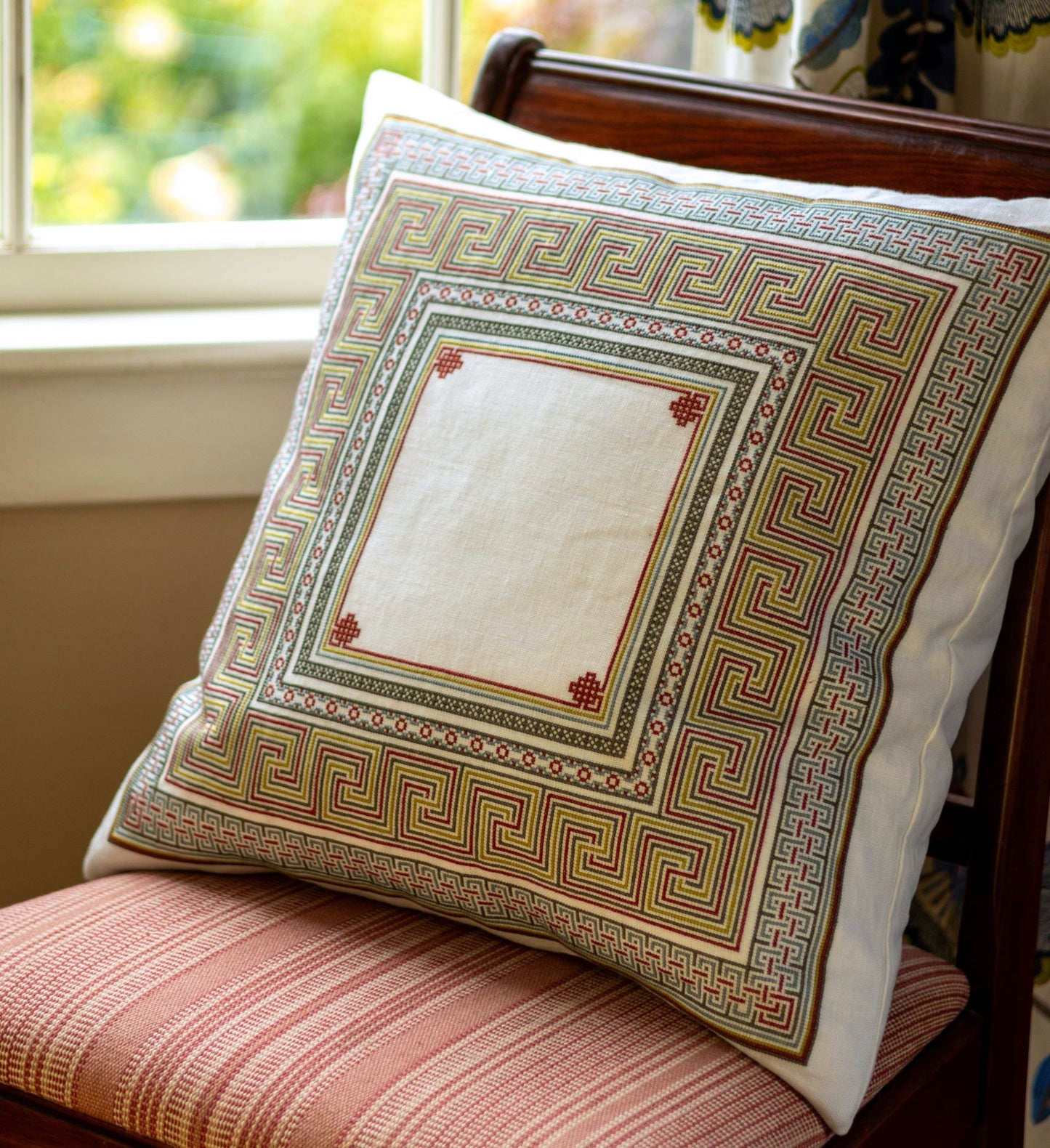 folk embroidery cushion with meander design