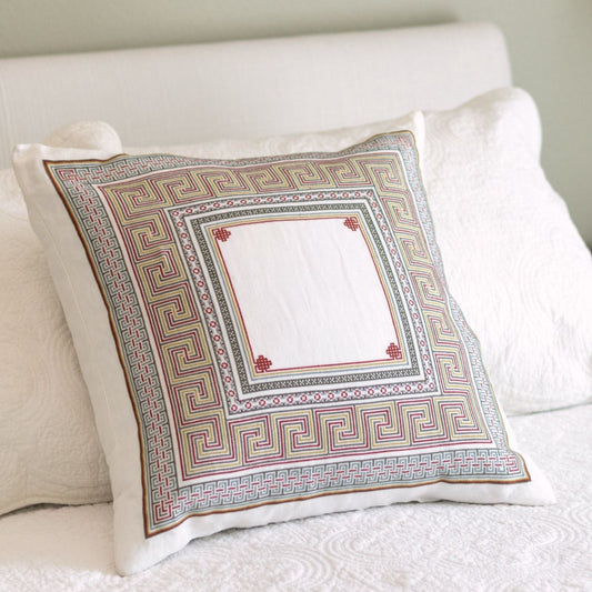 Somerset Meander cross stitch folk embroidery cushion cover with its perimeter meander border in terra cotta and warm blue