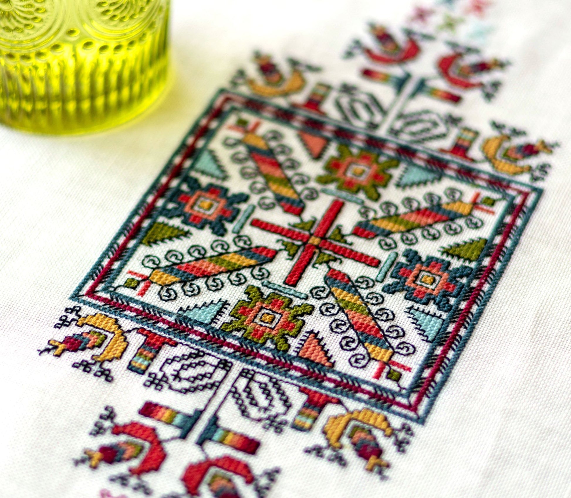 folk embroidery with geometric square design in multi colors