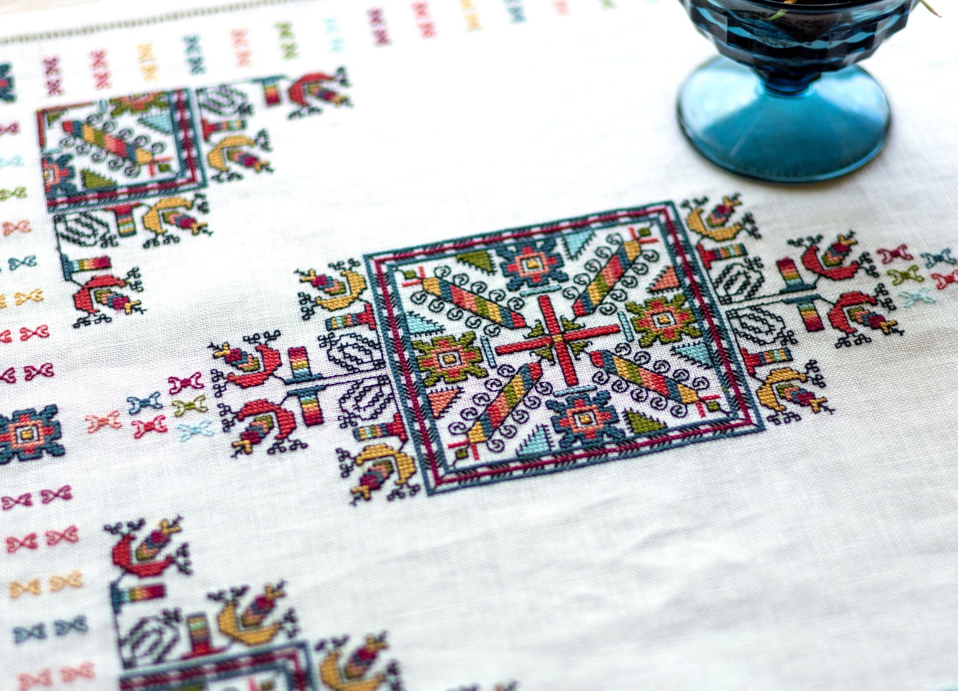 folk embroidery with geometric square design in multi colors