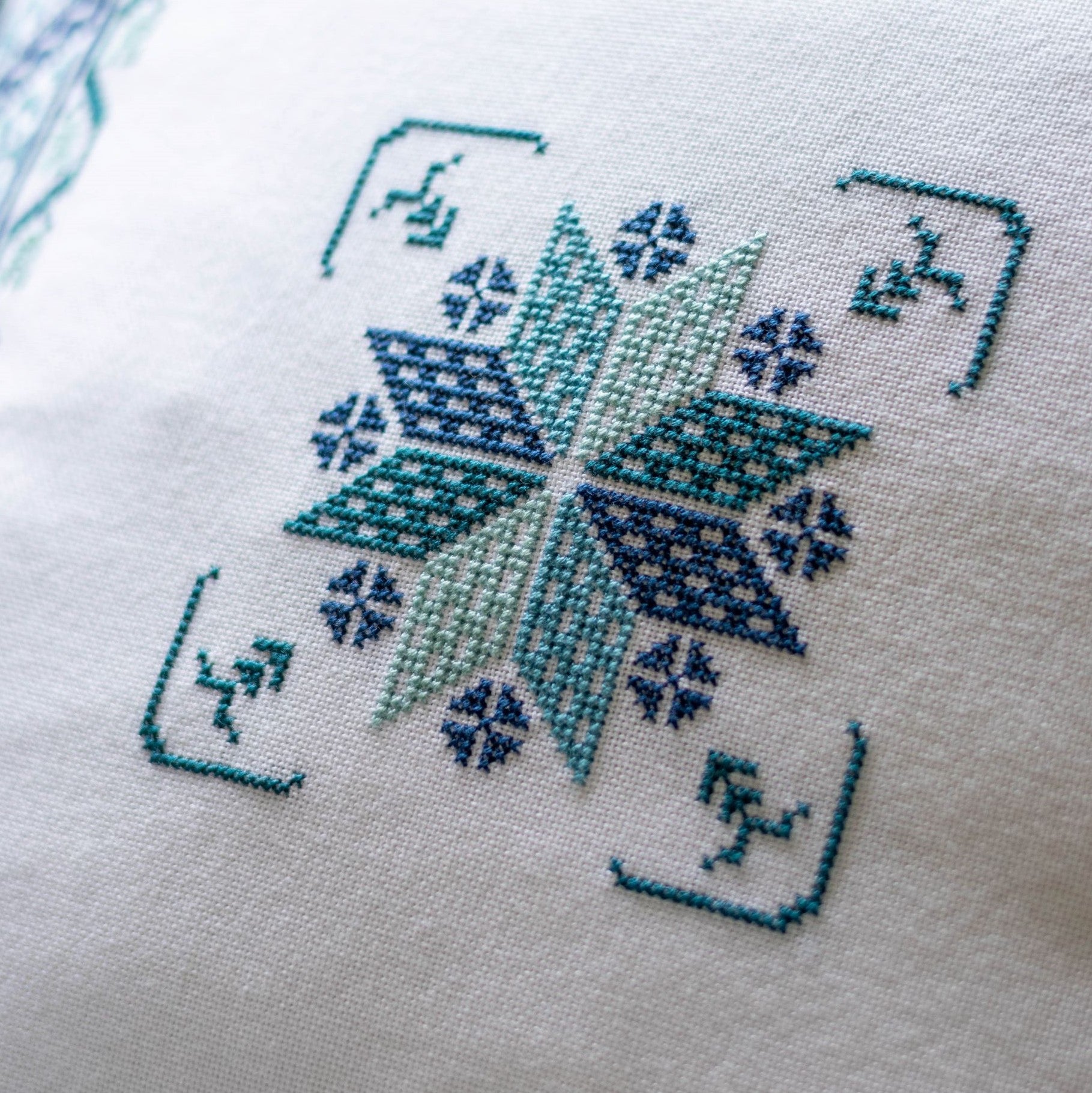 folk embroidery cushion with blue star design