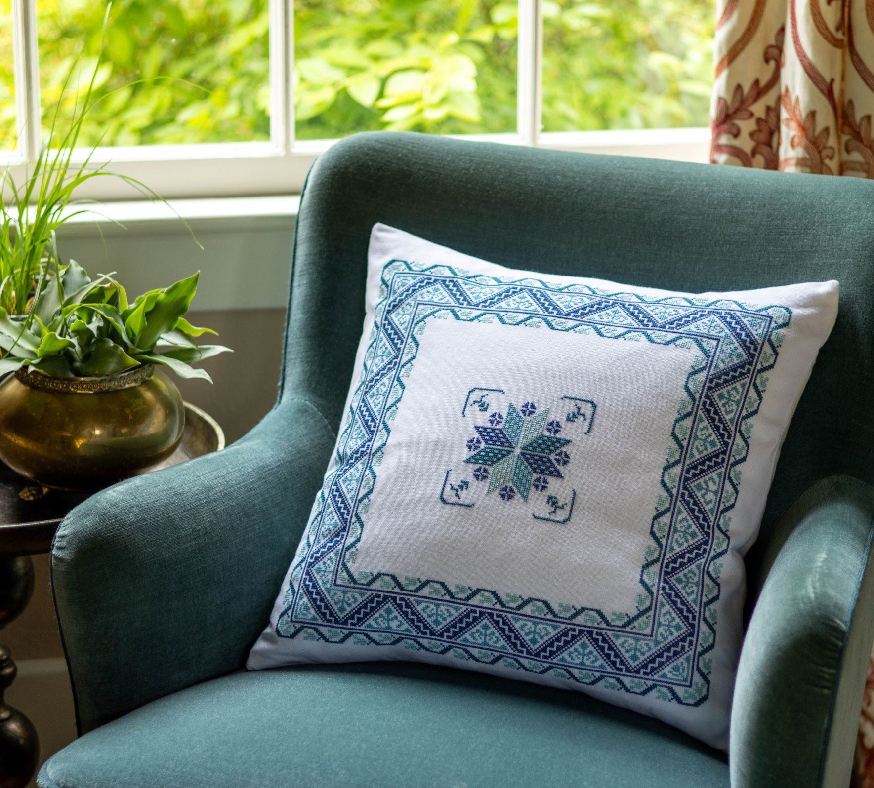 folk embroidery cushion with blue border design