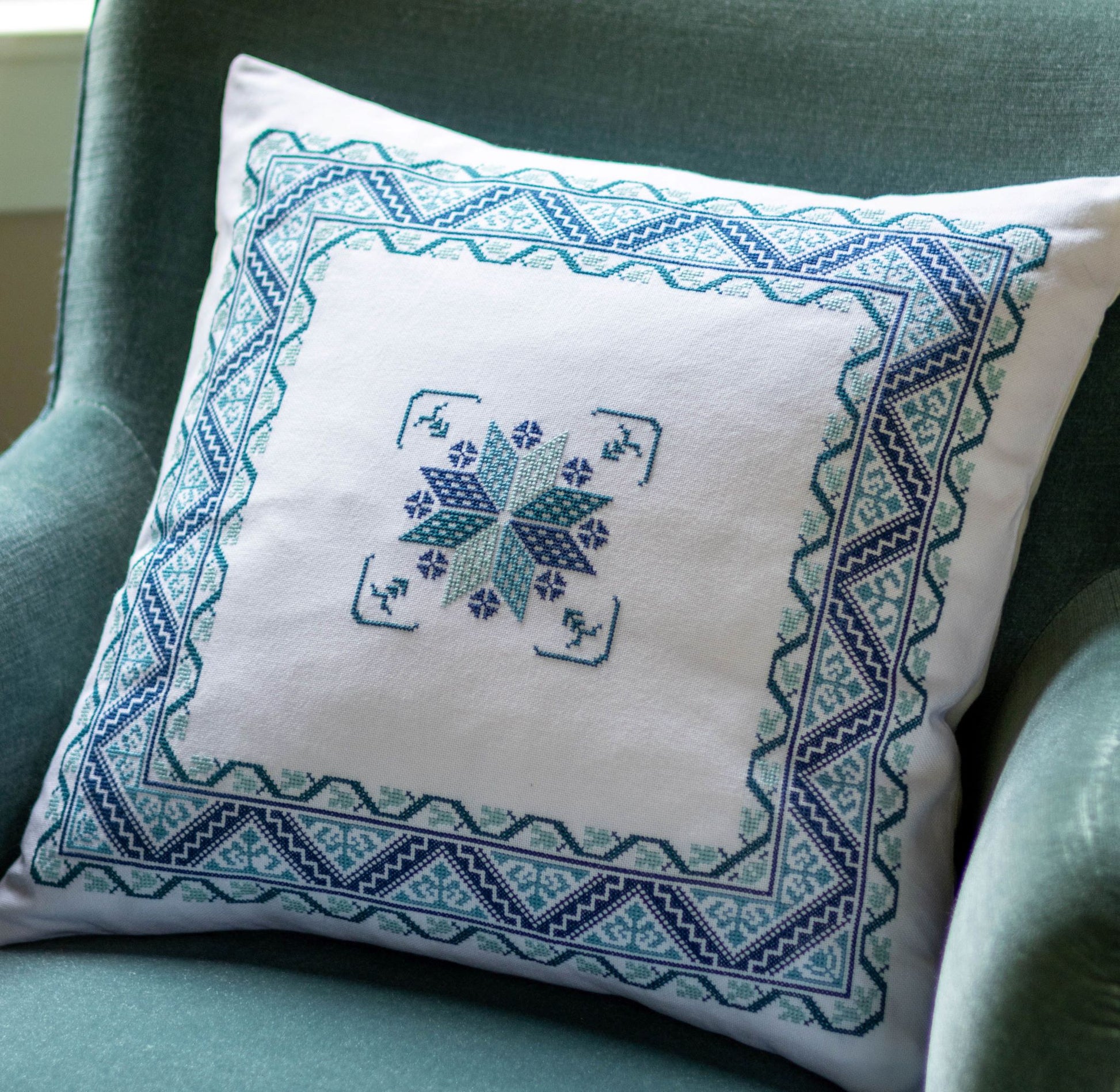 folk embroidery cushion with blue border design