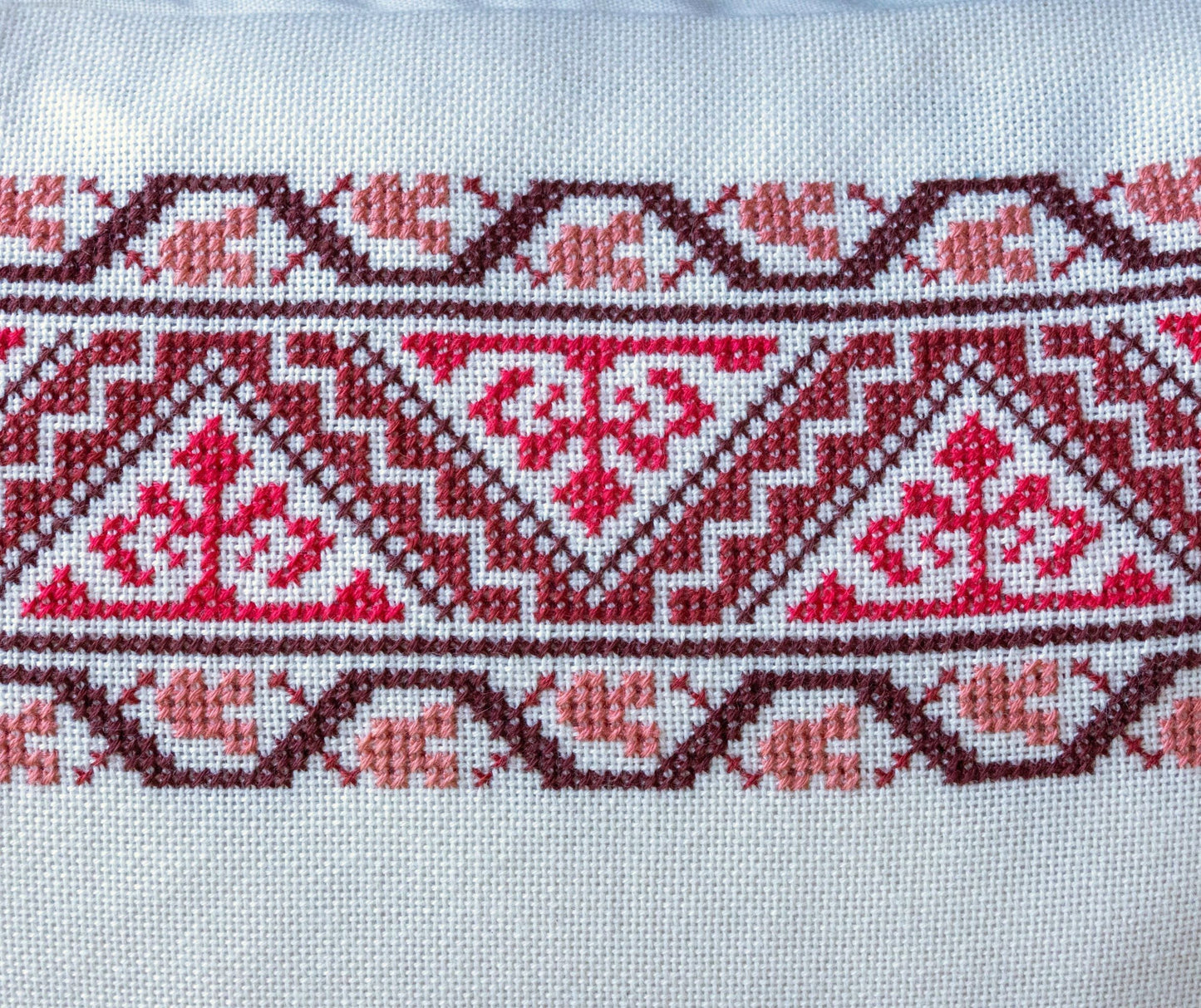 folk embroidery cushion with red border design