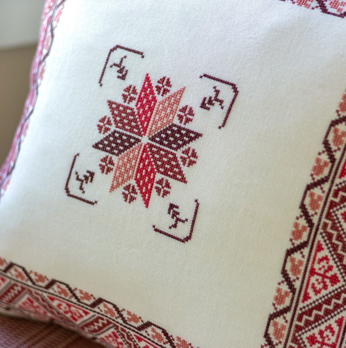 folk embroidery cushion with red border design